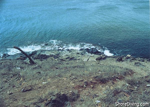 Make your way down this loose gravel path to the lava shelf, and slip into the sea.