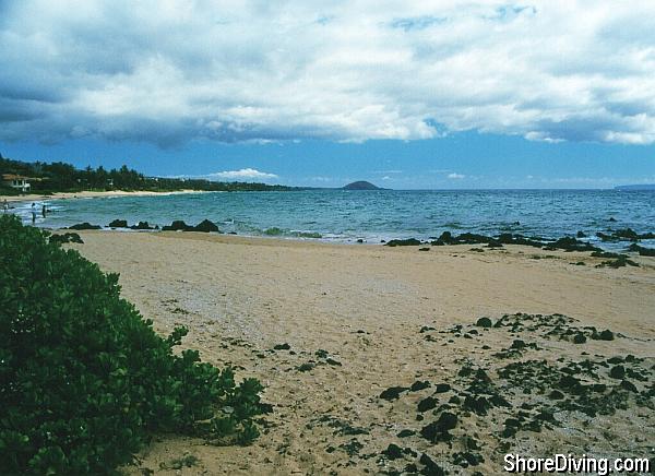 Walk to the far edge of the lava formation to make your sandy beach entry.