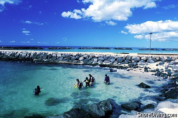The lagoon is in the background, and the small scuba entry beach is just on the right.  Kick out along the jetty until the sites become more interesting, --descend and enjoy!