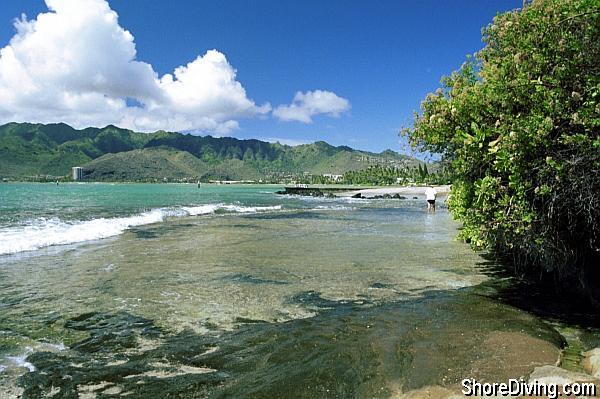 Following the path to the water's edge, you'll be greeted by a gentle shelf in front of you, and a nice beach to the right.  Choose your most comfortable entry point.