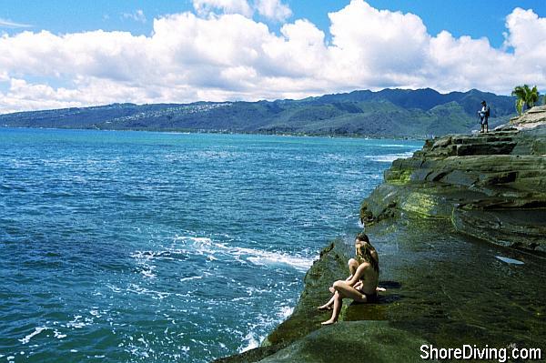 The entrance to the shelf is up above, and the girls have their feet on the natural step.  Do not leave any gear close to the edge.  A rogue wave could come along and gently sweep all your possessions out to sea!