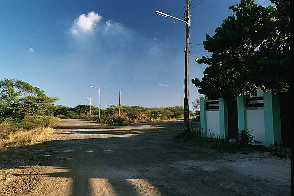 After the last house on the right, follow the dirt road to the beach.