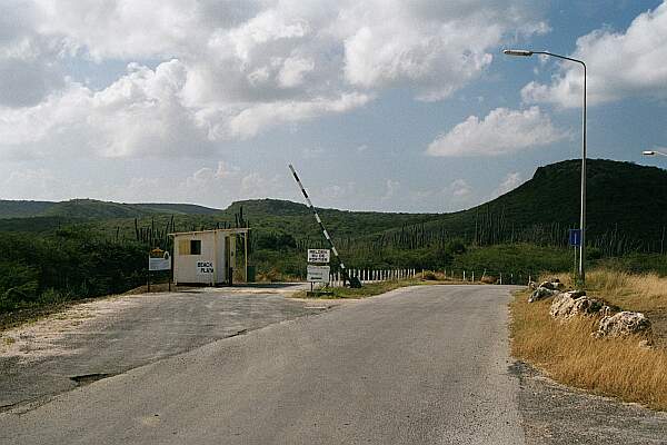 A bit down the road, you'll find a fork to the left with a small shack and gate.  If someone is there, they'll ask for about 10 guilders.  It's worth it!