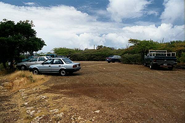 Parking is on a hard-packed dirt lot overlooking the beach area.