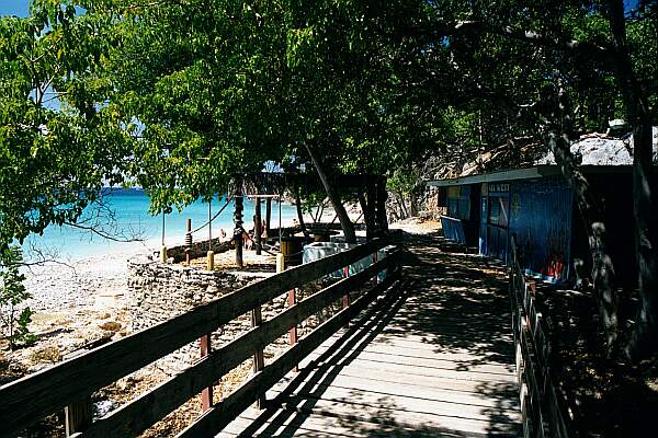 Head across this bridge.  Snack bar and restroom to the right, entry to the left!