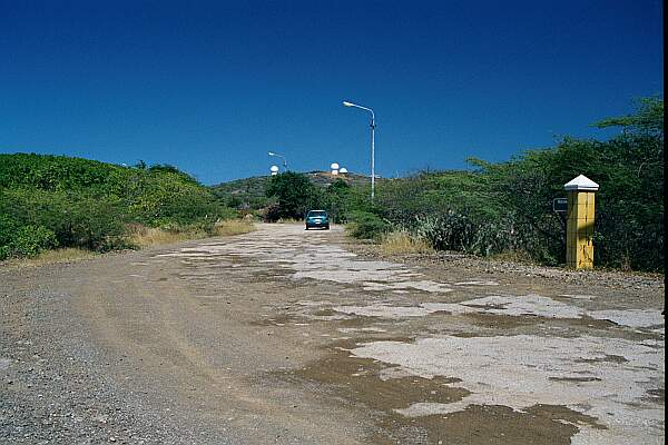 As you see this view, with the white buildings on the hilltop, turn left into the parking area.