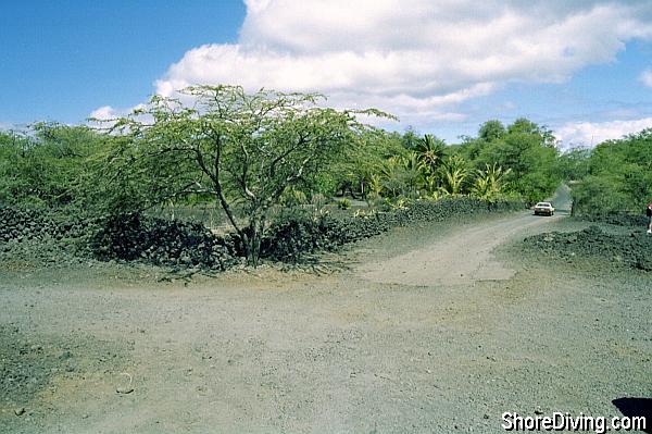 The end of the pave road (from which you came) is straight ahead, and the lava road entrance to La Perouse is to the the left.