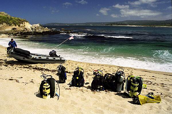 The surf is relatively calm on this day.  Here, some divers are taking the inflatable around the point.