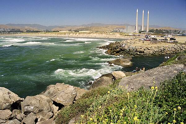 With the beach entry in the background, you can see clearly the surf you will encounter.  To the right is a cooling water outlet of the local power plant.  There is always a current coming from this channel, so returning along the jetty will be impossible.  You will have to return from the open sea.