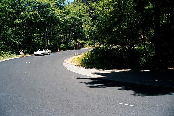 At the bottom of a sharp curve in the highway, you'll see a one lane road in the shade of the trees heading to the beach.  The gate will be closed, but you can drop your equipment off here and park at the top of the hill.