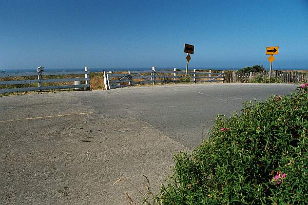 Where Main Street makes a sharp right, find some convenient parking.  The trail head is through the opening in the fence.