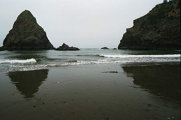 Pick your entry.  If the surf is amenable, kick out between the cliff and the rock.  Otherwise, move further down the beach.