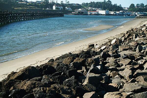 Carefully transverse the rocky jetty to the beach, and head out to end of the dock, where it falls off to about 45 feet.