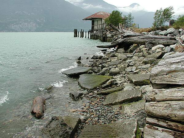 To the left of the parking, you'll find the remnants of an old concrete boat ramp.  Carefully climb down, and it will be easy going from there!